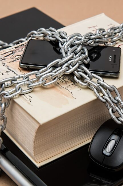 computer and phone in chains