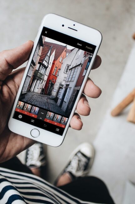 person holding iphone with opened photo editor