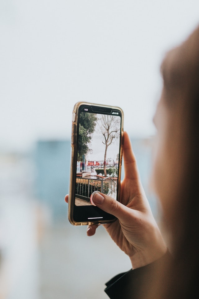 person taking a photo on iphone